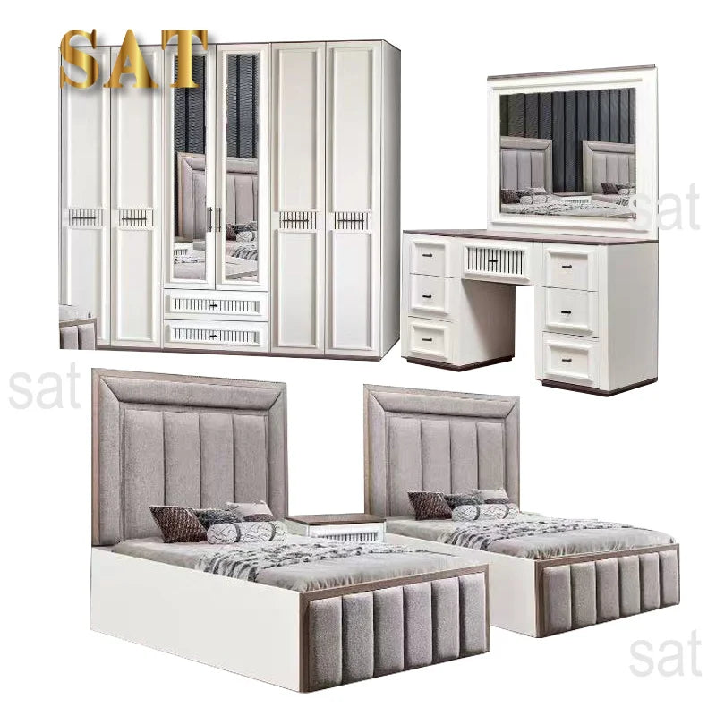A bedroom furniture set shown on a white background, including a tall white wardrobe with mirrored doors, a matching white desk and mirror vanity, and two single beds with upholstered gray tufted headboards and footboards. The image has a gold 'SAT' watermark and faint 'sat' text around the edges.