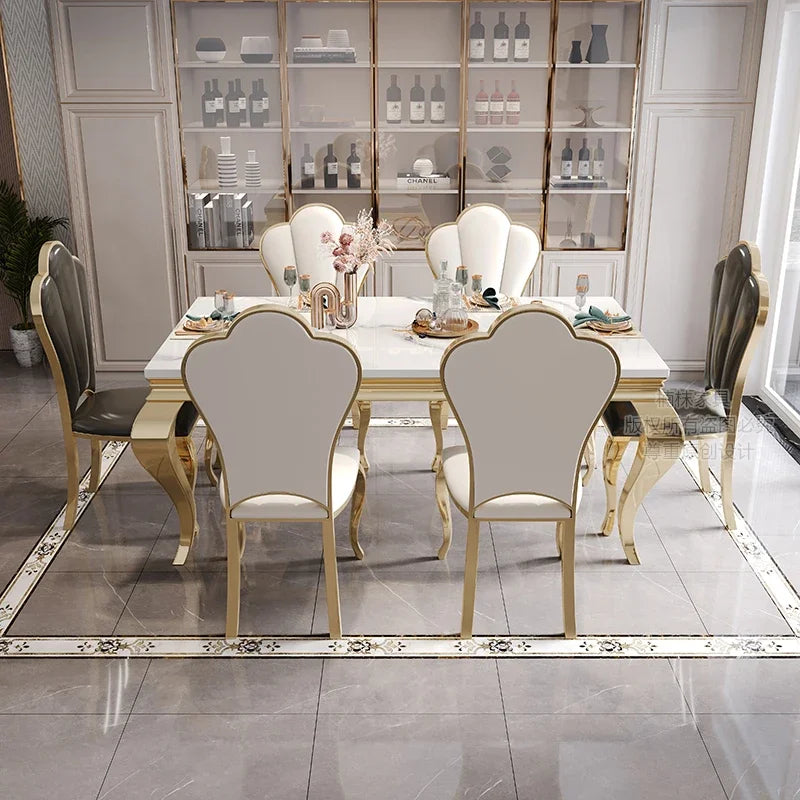 Dining room with a gold and white table and chairs in a modern interior setting.