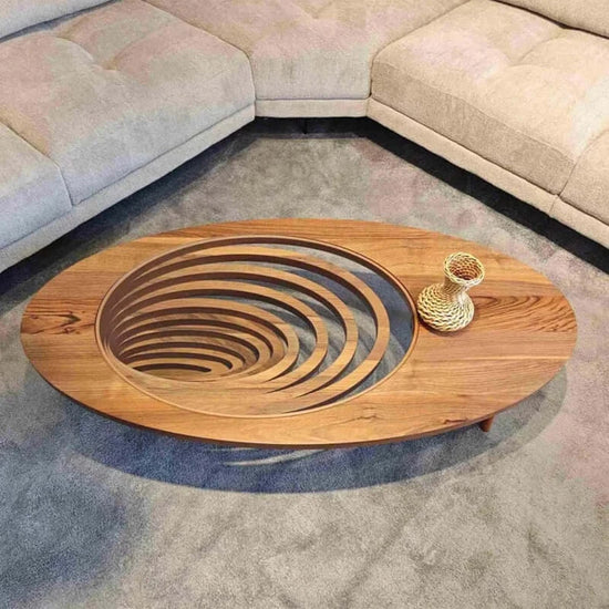 Wooden coffee table with spiral design in a living room setting