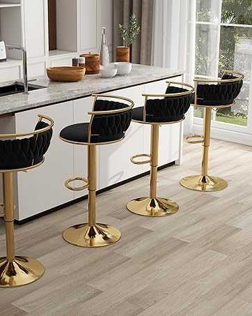 Four black and gold bar stools in a modern kitchen setting.