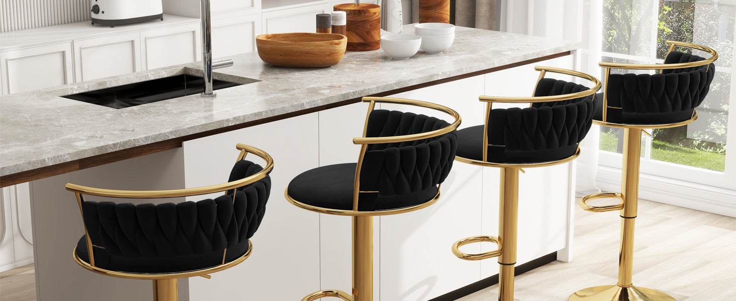 Black bar stools with gold legs in a modern kitchen setting