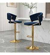 Two bar stools with blue seats and gold bases on a gray floor.