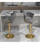 Two gray bar stools with gold bases in a modern kitchen setting.