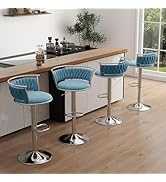 Three blue bar stools with chrome bases in a modern kitchen setting.
