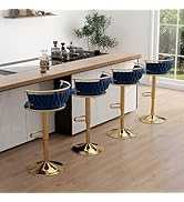 Three blue bar stools with gold bases on a kitchen counter.