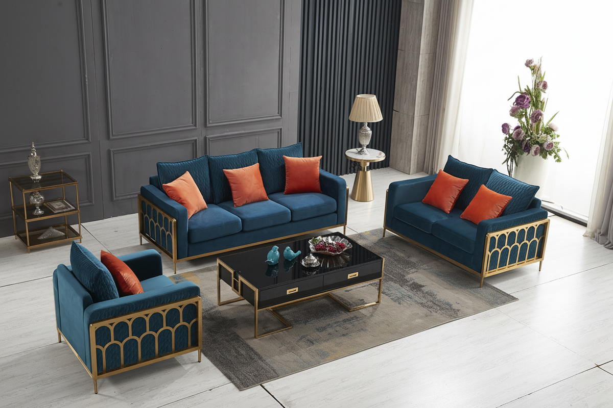 A luxury modern living room furniture set featuring a deep blue velvet sofa, matching armchair, loveseat, and a black coffee table with gold accents, styled in a contemporary room with gray paneled walls.