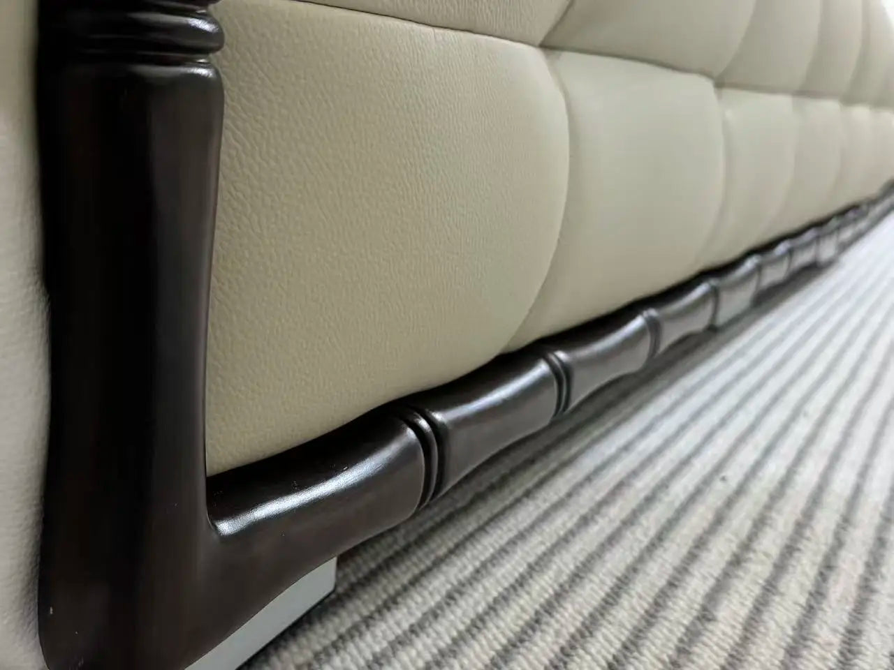 Close-up of the armrest on a customizable luxury modular sectional sofa with eco-leather and elegant design.