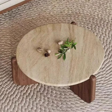 Round stone table with wooden legs on a textured surface