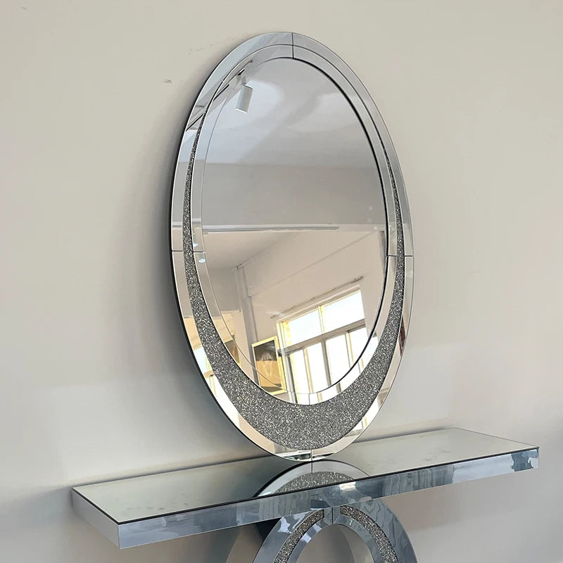 Round mirror with decorative frame on a white wall