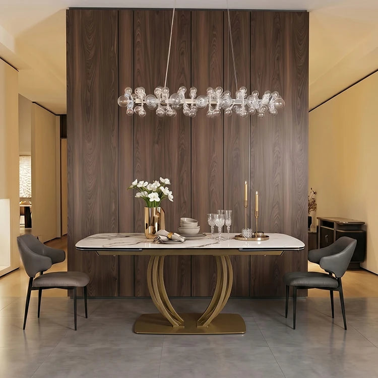 Modern dining room featuring an extendable sintered stone dining table with metal frame and elegant decor.
