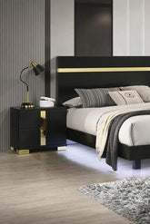 Modern bedroom with black bed frame, nightstand, and decorative pillows.