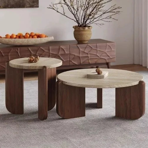 Two round coffee tables with wooden legs and marble tops in a living room setting.