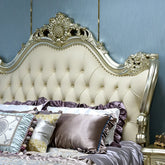 Decorative bed with ornate headboard and pillows against a blue wall.