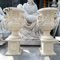 Luxury beige marble garden planter pot with ornate detailing, featuring a sculptural base for opulent outdoor design.