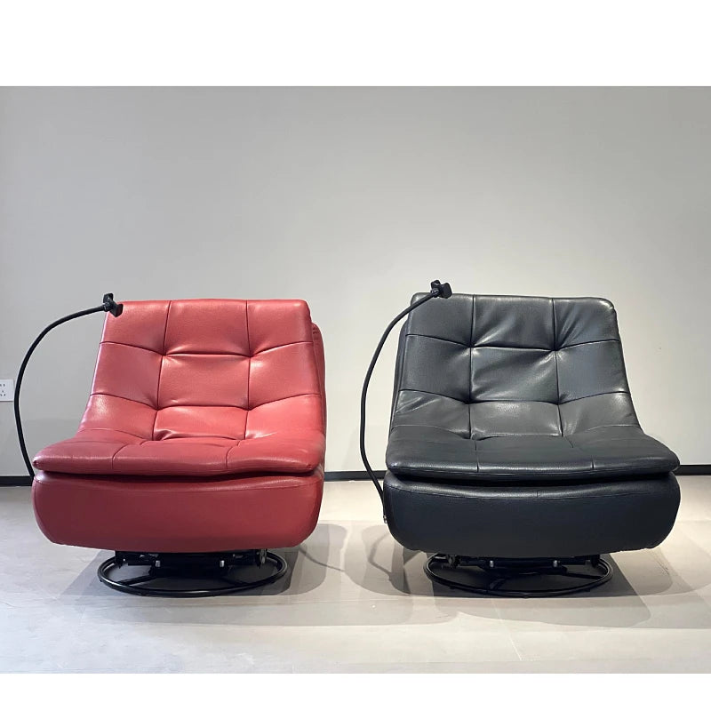 Two modern tufted swivel armchairs with integrated black floor lamps, shown side by side. The left chair is upholstered in red leather, and the right chair is upholstered in dark gray leather, both on black swivel bases against a plain light gray wall.