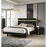 Modern bedroom with black and gold bed, nightstands, and decor.