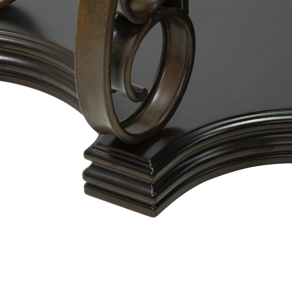 Close-up of the ornate metal frame of a modern metal and glass coffee table, showcasing its luxurious design and craftsmanship.