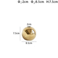 Gold spherical object with dimensions labeled on a white background