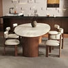 Round dining table with chairs in a room setting