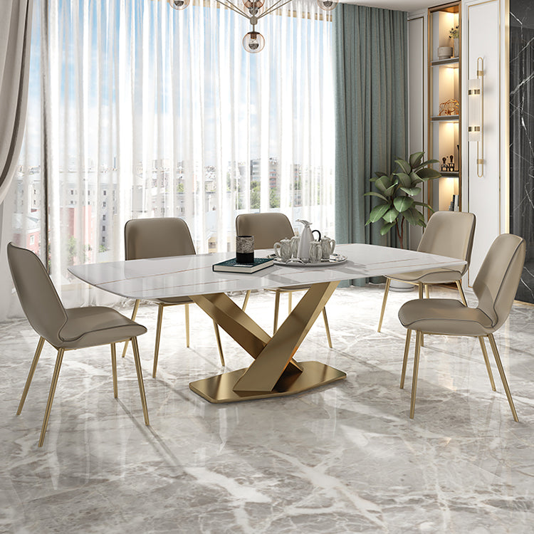 Modern dining room with a marble table and chairs in a well-lit room.