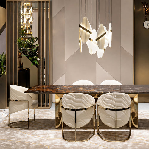 Brown marble dining table set with elegant white chairs and modern lighting in a stylish dining space.