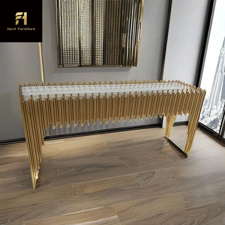 Modern console table with gold accents in a room with large windows.