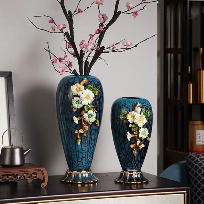 Handcrafted decorative vases set featuring floral accents in a beautiful blue glaze, perfect for luxury home decor.