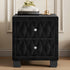 Black tufted nightstand with decorative knob on a wooden floor.