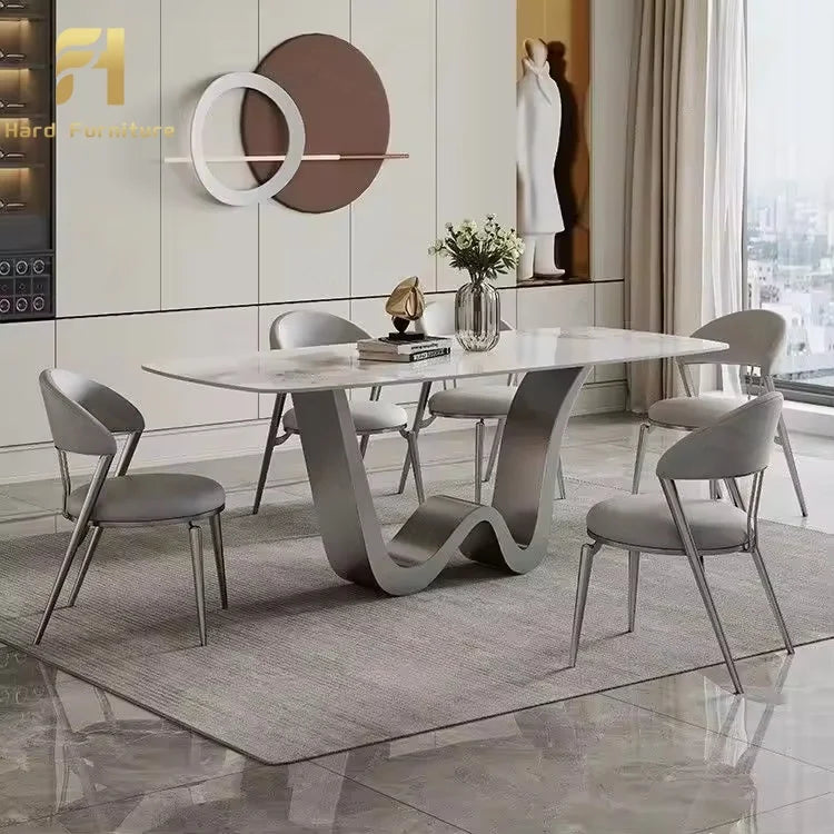 Luxury marble dining table with gold legs surrounded by modern chairs in a stylish dining area.