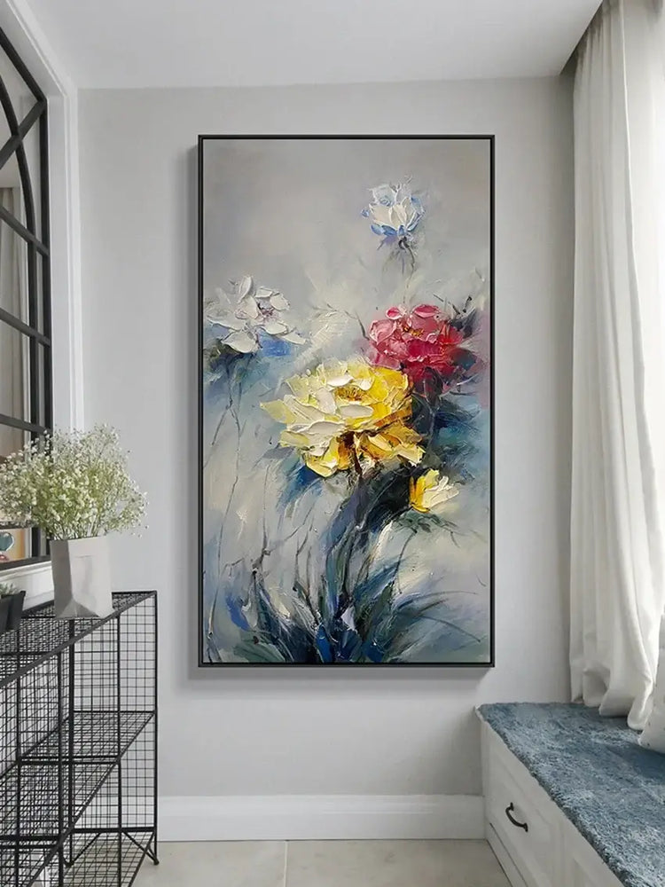 Floral painting on a wall in a room with a black metal shelf and white bench.
