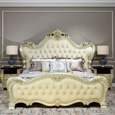 Luxurious cream-colored bed with intricate designs in a bedroom setting.
