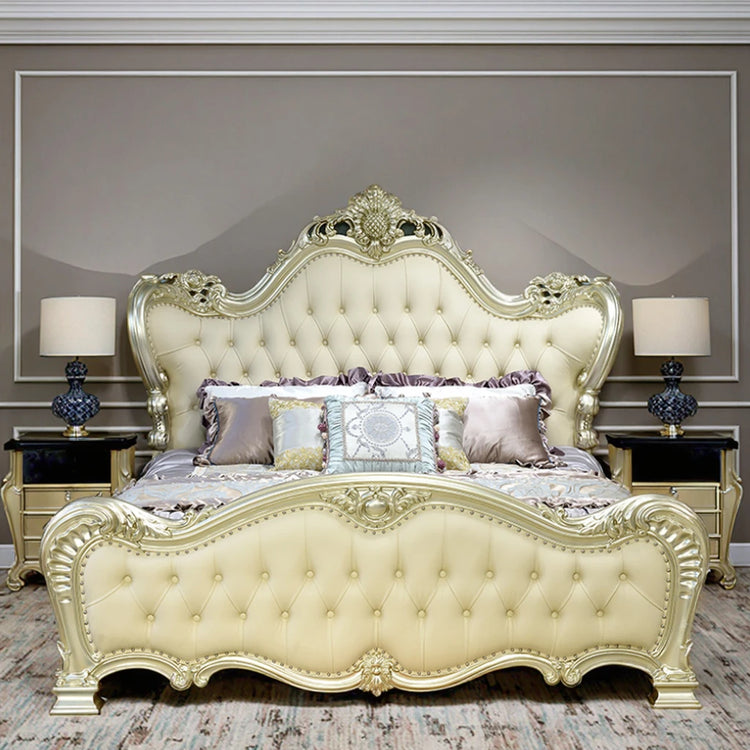 Luxurious cream-colored bed with intricate designs in a bedroom setting.