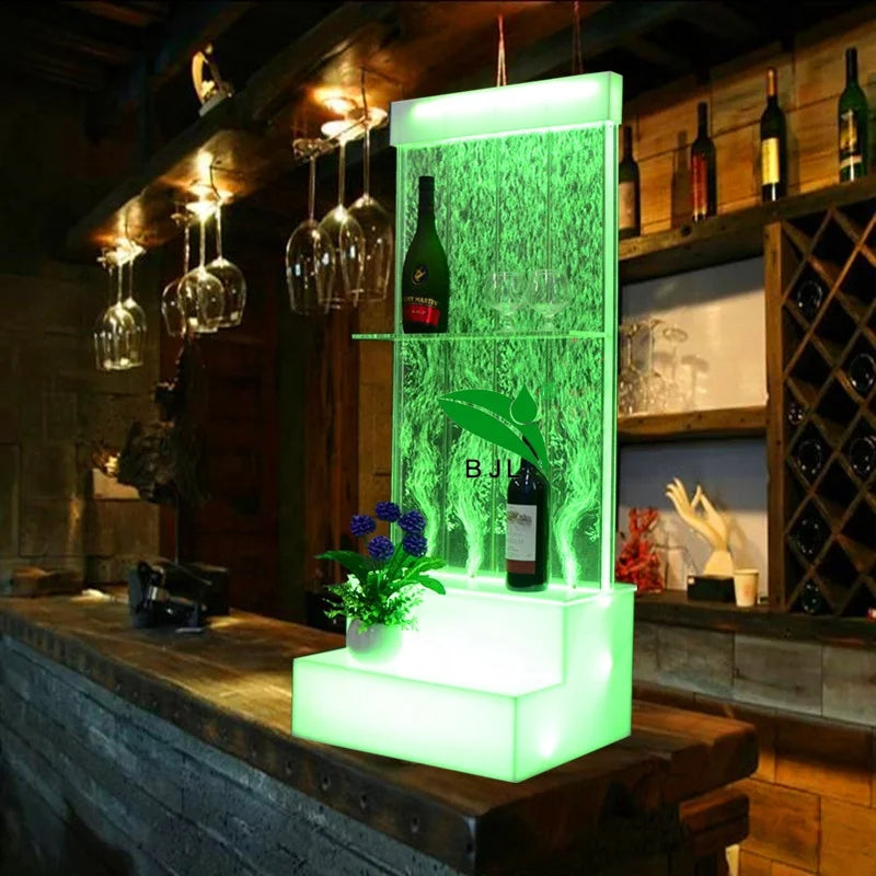 Acrylic water bubble bar cabinet with LED lights and bottles on display shelves.