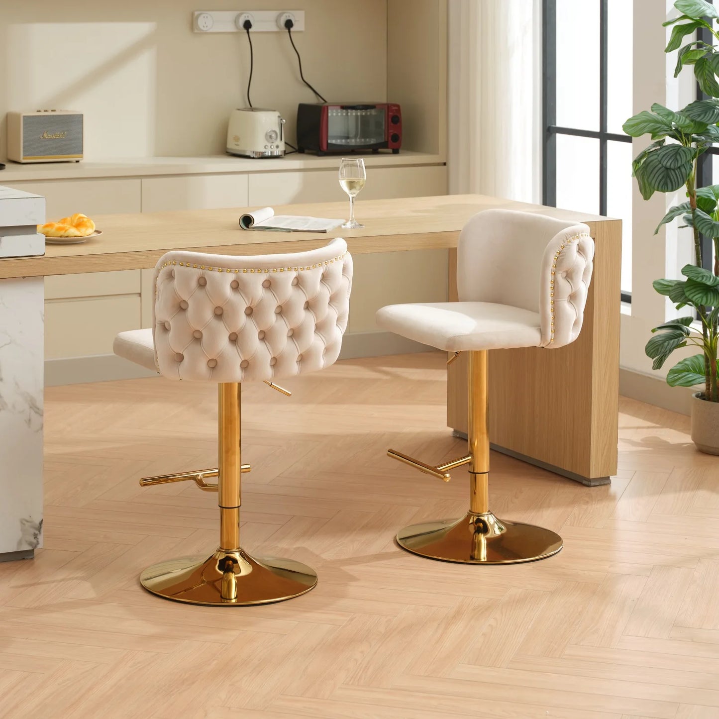 Set of 2 Leather Swivel Adjustable Bar Stools with golden base in a stylish kitchen setting.