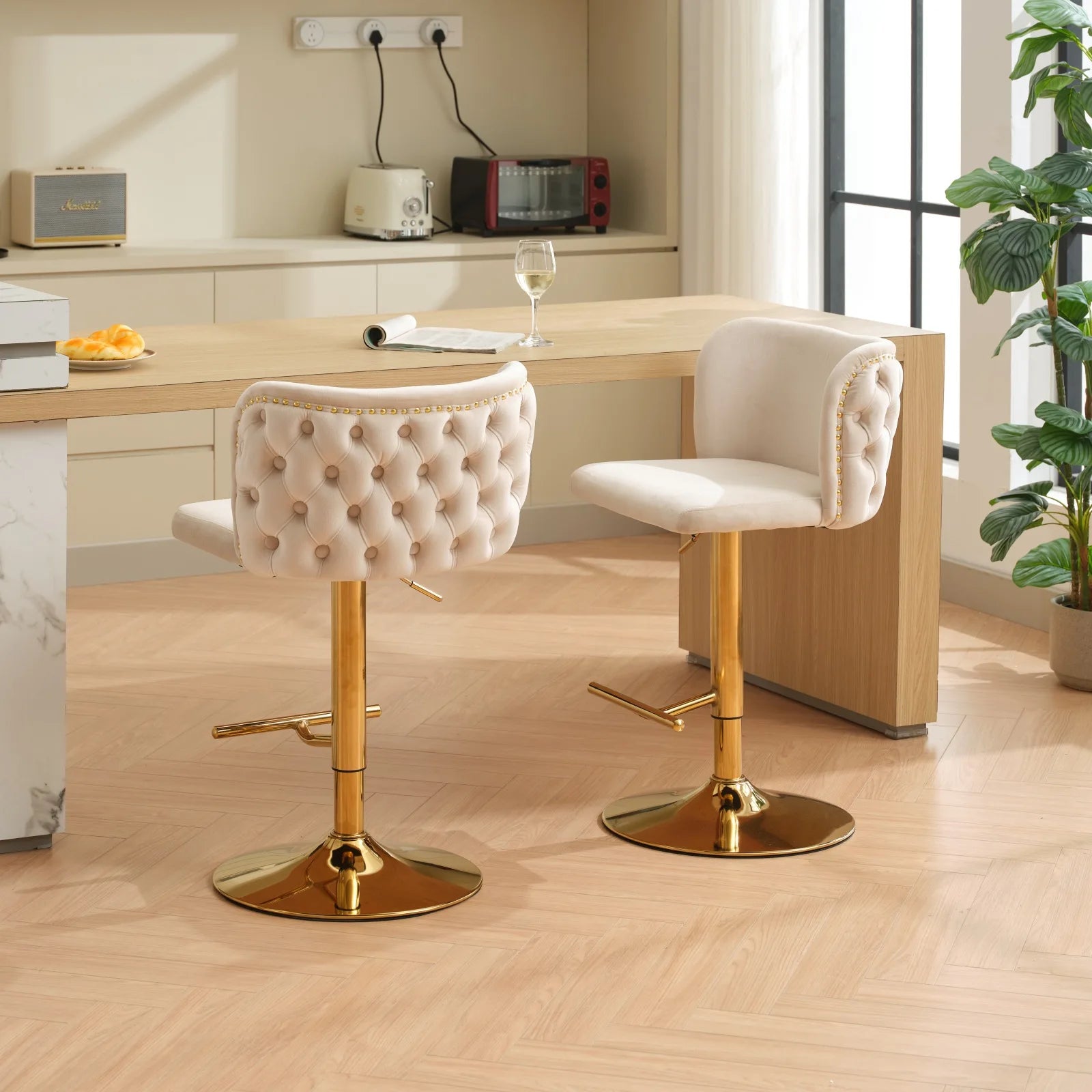 Set of 2 Leather Swivel Adjustable Bar Stools with golden base in a stylish kitchen setting.