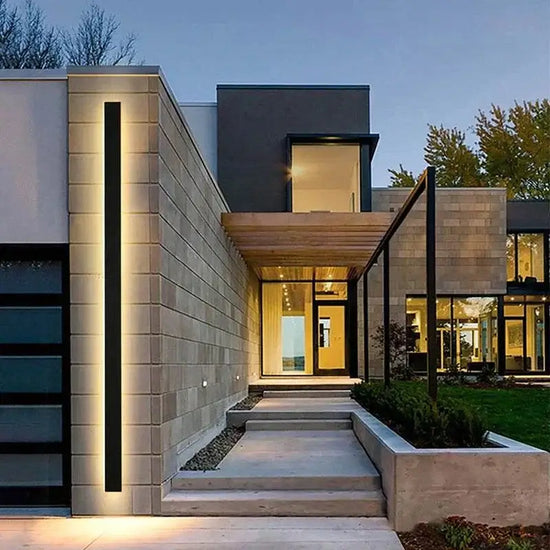modern waterproof outdoor wall light illuminating a stylish contemporary home entrance at dusk.