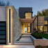 modern waterproof outdoor wall light illuminating a stylish contemporary home entrance at dusk.