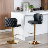 Two black bar stools with gold bases in a kitchen setting.