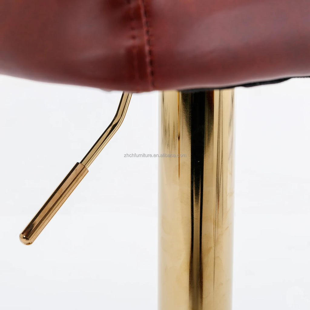 Close-up of Leather Swivel Adjustable Bar Stools height adjustment lever and golden base for modern design.