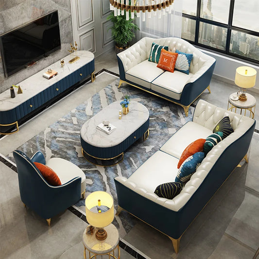 Modern living room with blue and white furniture, including sofas and a coffee table.