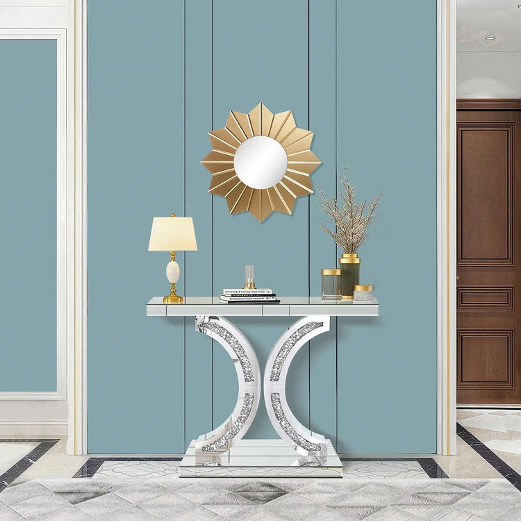 Decorative console table with a lamp and mirror against a blue wall.
