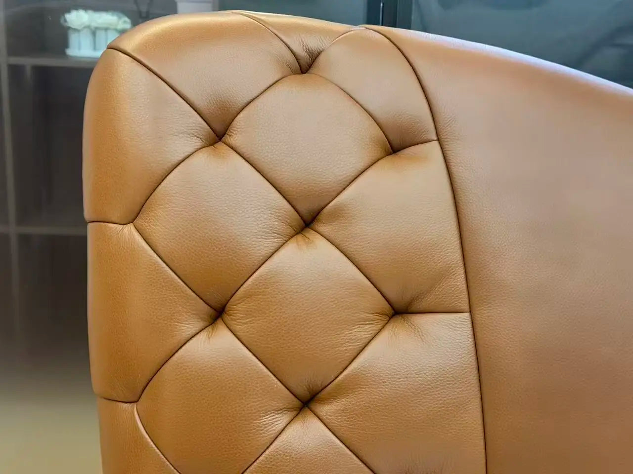 Close-up of luxury upholstered storage bed with massage top-grain cowhide leather headboard design.