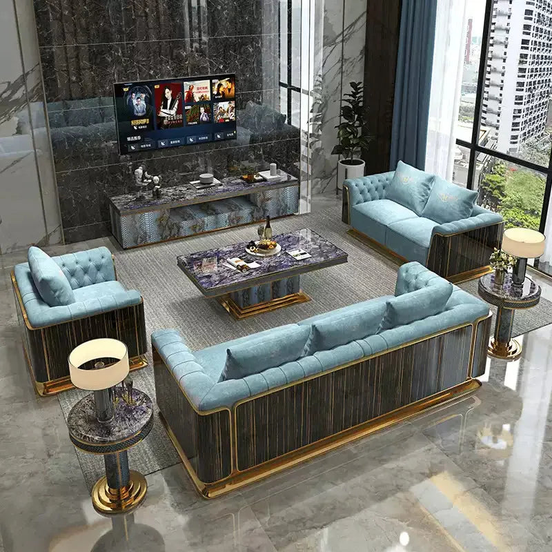 Luxury modern living room set featuring a light blue tufted sofa, matching armchair, and a three-seat sofa with dark wood paneling and gold trim, arranged around a marble coffee table in a high-end interior.