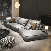 Modern living room with a gray sectional sofa and decorative pillows.