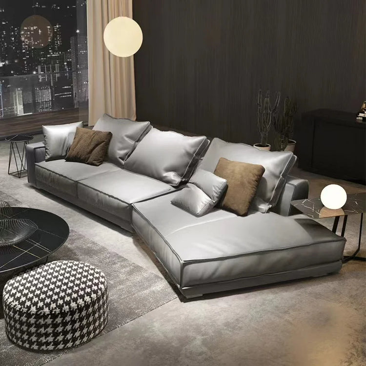 Modern living room with a gray sectional sofa and decorative pillows.