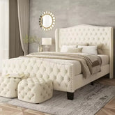 Neatly made bed with tufted headboard in a bedroom setting