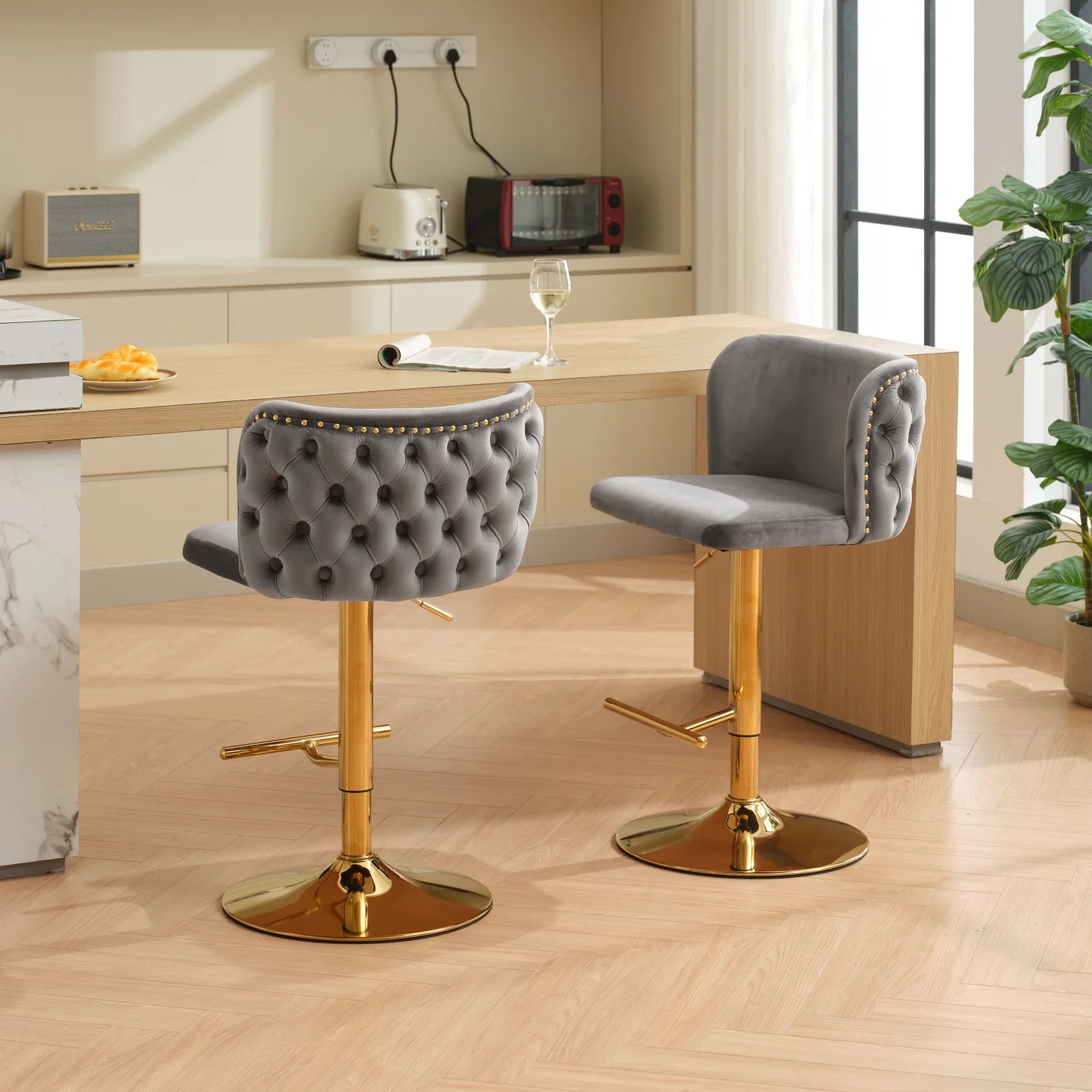Set of 2 Leather Swivel Adjustable Bar Stools with tufted gray upholstery and golden bases in a modern kitchen setting.