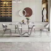 Modern dining room with a stylish table and chairs in a showroom setting.