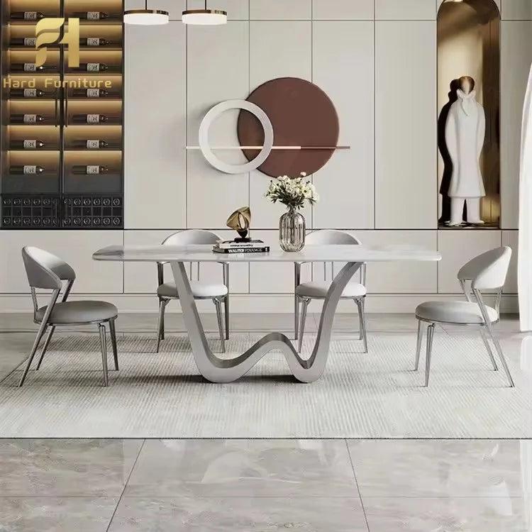 Luxury marble dining table with gold legs surrounded by elegant chairs in a modern dining room setting.