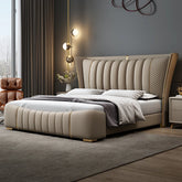 Beige upholstered bed in a modern bedroom setting with decorative elements.